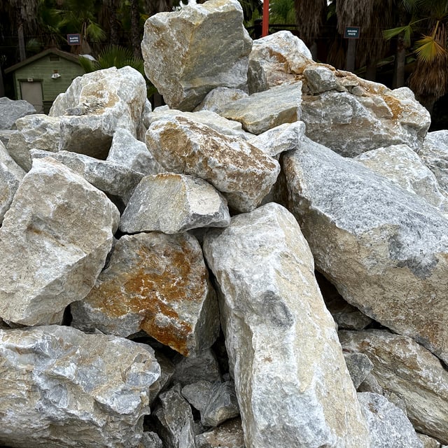 Golden White boulders in bulk at rock yard