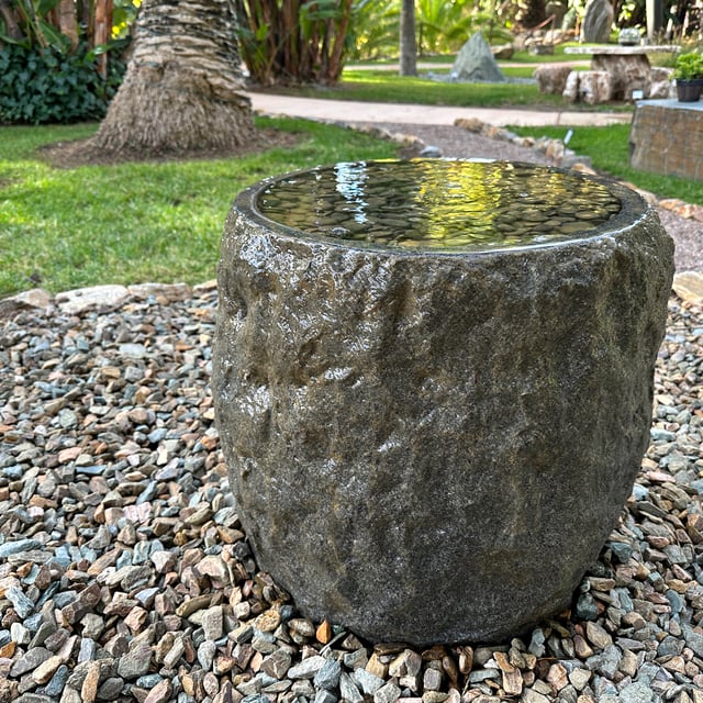Infinity Stone Fountain displayed with crushed rock for sale at rock yard