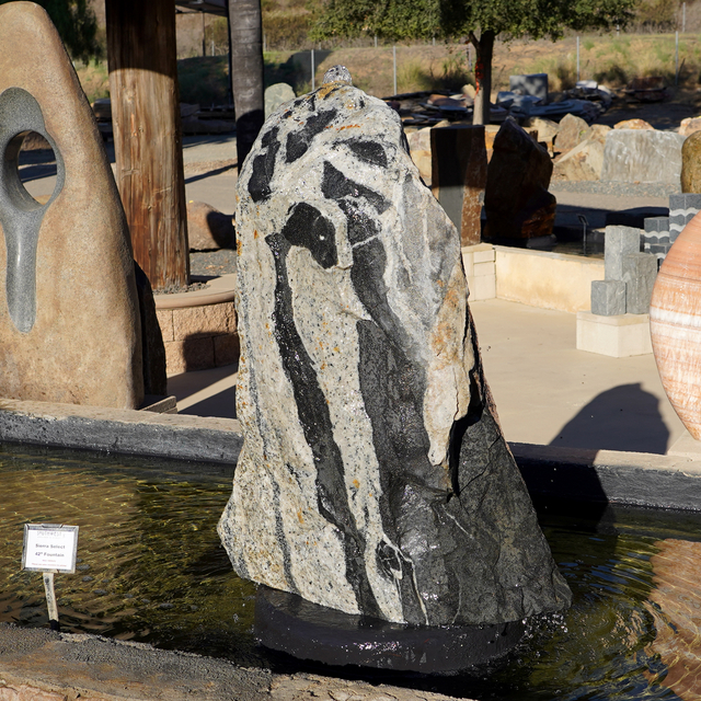 Sierra Select Natural Boulder Fountain displayed in water feature showcase at rock yard
