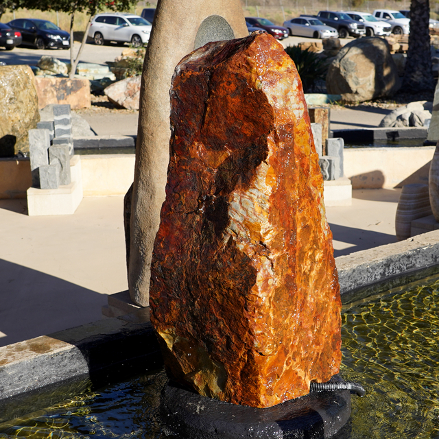Baja Cresta Natural Boulder Fountain displayed in pond for sale at rock yard