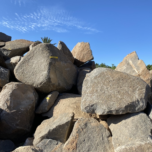 Smoked Patina Boulders in pile for sale at Southwest Boulder & Stone