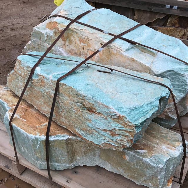 Turquoise landscape boulders in rock yard
