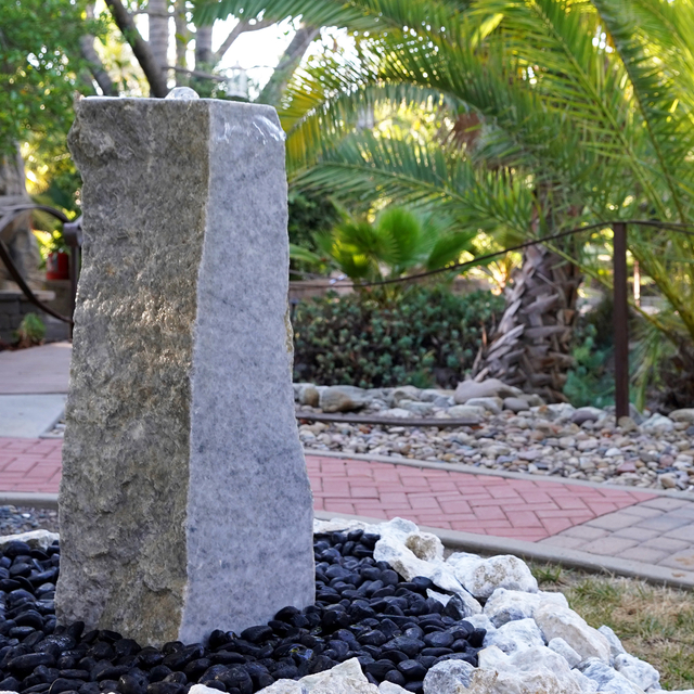 Golden White Fountain installed with polished black pebble and white crushed rock