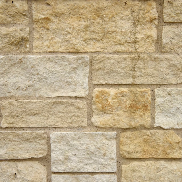 Austin Cream Stone Veneer Natural Ledgestone on rock wall project
